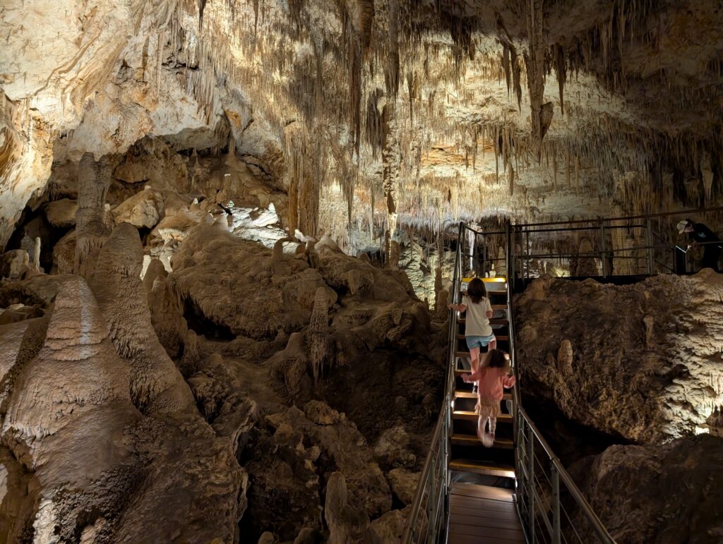 Two kids climbing the stairs in Mammoth Cave, Western Australia